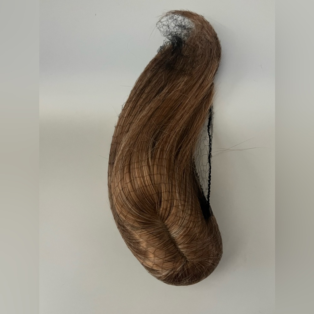 Brown hair is a ponytail